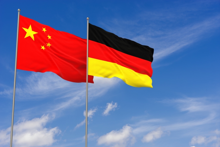 China and Germany flags over blue sky background. 3D illustration