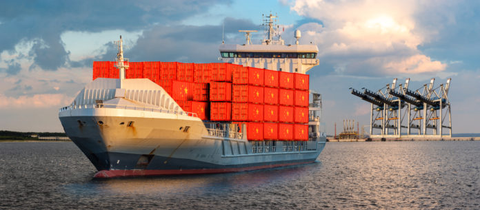 container ship at sea carrying containers with the flag of China