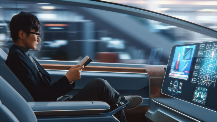 Futuristic Concept: Businessman in Glasses Reading Notebook and Watching News on Augmented Reality Screen while Sitting in a Autonomous Self-Driving Zero-Emissions Car.