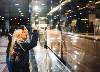 Blonde woman and asian woman go shopping.