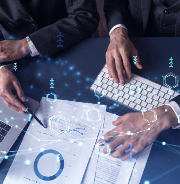 Two research and development specialists man and woman working on project to create a new approach to develop software to improve business. Technological icons over the table with document.