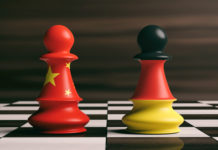 China and Germany flags on chess pawns on a chessboard. 3d illus