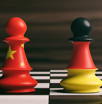 China and Germany flags on chess pawns on a chessboard. 3d illus