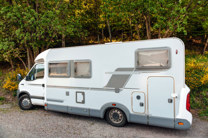 Camping van microbus parked in summer forest